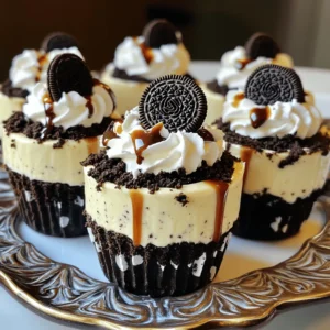 To make these yummy Oreo No-Bake Cheesecake Cups, you need: - 1 package (14-16) Oreo cookies, crushed - 4 tablespoons unsalted butter, melted - 16 ounces cream cheese, softened to room temperature - 1 cup powdered sugar - 1 teaspoon vanilla extract - 2 cups heavy whipping cream - 12 additional Oreo cookies, finely crushed for topping - Chocolate syrup (optional, for drizzling) You will need some basic tools to make this easy treat: - Mixing bowls - Electric mixer or hand mixer - Measuring cups and spoons - Spoon or spatula - Dessert cups or jars for serving - Plastic wrap or lids for chilling You can swap some ingredients if needed: - Use gluten-free Oreo cookies for a gluten-free option. - Swap cream cheese for dairy-free cream cheese if you want a dairy-free dessert. - If you don’t have heavy cream, use whipped topping. It works well too. - You can use any sweetener instead of powdered sugar, but it may change the taste. These ingredients and tools will help you create these delightful Oreo No-Bake Cheesecake Cups from the full recipe. Enjoy the fun of making this sweet treat! To start, you need to make the Oreo crust. In a medium bowl, mix together the crushed Oreo cookies and melted butter. Stir until the crumbs look like damp sand. This step is simple but key. It gives your cheesecake a great base. Next, take your mixture and divide it evenly among dessert cups or jars. You want each cup to have a good layer of crust. Use the back of a spoon or your fingers to press it down. Make it nice and compact. After that, put the cups in the fridge to chill. This helps the crust firm up while you work on the filling. Now it’s time to whip up the cheesecake filling. Start with a large mixing bowl. Beat the softened cream cheese with a hand mixer. Mix until it’s smooth and creamy. This step is crucial for a lump-free filling. Once your cream cheese is smooth, add the powdered sugar and vanilla extract. Keep mixing until everything is well combined. The mixture should look fluffy and light. In another bowl, whip the heavy cream. Use an electric mixer until stiff peaks form. This means the cream holds its shape when you lift the beaters. Gently fold this whipped cream into your cream cheese mixture. Be careful not to deflate it. Fold until it’s fully mixed and light. Take your chilled cups from the fridge. Spoon the cheesecake filling on top of the Oreo crust. Fill each cup to just below the rim. This leaves room for toppings later. Now for the fun part! Sprinkle the finely crushed Oreo cookies on top of the filling. This adds texture and flavor. Finally, cover the cups with plastic wrap. Chill them in the fridge for at least four hours. This helps the cheesecake set up nicely. If you want, drizzle chocolate syrup on top before serving. Follow the Full Recipe for more details and tips! When making Oreo No-Bake Cheesecake Cups, avoid using cold cream cheese. Cold cream cheese can create lumps. Always let it soften to room temperature. Another common mistake is not whipping the cream enough. It should form stiff peaks. If the cream is too soft, your cheesecake may not set well. Lastly, don’t overmix the whipped cream with the filling. Gentle folding keeps it airy. For a smooth texture, ensure all your ingredients are at room temperature. This helps them blend well. Mix the cream cheese until it’s very creamy and lump-free. While folding in the whipped cream, use a spatula and be gentle. This keeps the mixture light and fluffy. Allow the cups to chill for at least four hours. This helps the flavors meld and the texture firm up nicely. To make your cheesecake cups extra special, top them with a half Oreo and a dollop of whipped cream. This adds a nice touch. You can also drizzle chocolate syrup for a sweet finish. For fun, serve these cups on a colorful platter or with decorative spoons. This makes them eye-catching and adds to the experience. For the full recipe, check out the complete guide to Oreo No-Bake Cheesecake Cups. {{image_4}} You can easily switch up the flavors in your Oreo No-Bake Cheesecake Cups. Here are some fun ideas: - Peanut Butter: Mix in ½ cup of creamy peanut butter with the cream cheese. - Mint: Add a few drops of mint extract for a fresh twist. - Chocolate: Blend in cocoa powder for a rich chocolate flavor. - Fruit: Fold in crushed strawberries or raspberries for a fruity touch. Each option brings a new taste. Feel free to mix and match! The toppings can make your cheesecake cups look great and taste even better. Here are a few ideas: - Whipped Cream: A dollop on top adds a light touch. - Fresh Berries: Use strawberries, blueberries, or raspberries for color and flavor. - Crushed Nuts: Sprinkle chopped nuts for a crunchy texture. - Caramel Sauce: Drizzle caramel for a sweet surprise. These toppings can change the whole vibe of your dessert! You can adapt this recipe for different diets. Here’s how: - Gluten-Free: Use gluten-free Oreo cookies for the crust. - Dairy-Free: Swap cream cheese with a dairy-free alternative, like cashew cheese. - Vegan: Use coconut cream instead of heavy cream and a vegan cream cheese. These changes make the treat suitable for more people while keeping it delicious. Check out the Full Recipe for detailed instructions! To keep your Oreo No-Bake Cheesecake Cups fresh, store them in the fridge. Use an airtight container to prevent them from absorbing odors. If you stack the cups, place a piece of parchment paper between them. This method keeps the layers intact and avoids mess. These cheesecake cups stay fresh for about 4 to 5 days in the fridge. After that, the texture may change, and the taste might not be as great. Make sure to check for any signs of spoilage before enjoying. You can freeze the Oreo No-Bake Cheesecake Cups for later use. Freeze them before adding the toppings. Place them in a freezer-safe container. They can last up to 2 months in the freezer. To thaw, move them to the fridge overnight. Add toppings just before serving for the best taste. No, you should not use regular cream cheese. Softened cream cheese works best for this recipe. It blends easily, creating a smooth and creamy texture. Regular cream cheese is too firm and may leave lumps in your cheesecake. Always let your cream cheese sit at room temperature for about 30 minutes before using. This simple step makes a big difference in your dessert's final texture. You can tell the cheesecake is set when it feels firm to the touch. After chilling for at least four hours, gently press your finger on the top. If it holds its shape and does not jiggle, it is ready. You can also check the edges. They should look slightly pulled away from the cup. This means the filling has set well. Yes, you can make these cheesecake cups in advance. They are perfect for meal prep or parties. Just store them in the fridge for up to three days before serving. This allows the flavors to blend and enhances the taste. If you plan to freeze them, do so without the toppings. Add the toppings after thawing for the best look and taste. You can find the full recipe in the recipe section. Oreo No-Bake Cheesecake Cups are fun and easy to make. We covered key ingredients, steps, and tips. You learned to avoid common mistakes for a perfect texture. Different variations let you be creative and suit dietary needs. Store your cups properly for best taste and freshness. Now, it’s time for you to try this tasty treat. Enjoy every bite and share with friends!