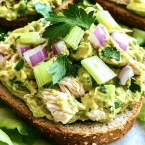 - 2 cups cooked chicken breast, shredded - 1 ripe avocado, fully mashed - 1/2 cup plain Greek yogurt - 1 tablespoon Dijon mustard - 1 tablespoon fresh lemon juice - Salt and freshly ground black pepper - 1/4 cup red onion, finely diced - 1/4 cup celery, finely diced - Fresh parsley, chopped (for garnish) For this easy and healthy avocado chicken salad, I focus on fresh and simple ingredients. The protein comes from chicken, which you can cook ahead of time. I like to use rotisserie chicken for added flavor and ease. The avocado acts as the creamy base, reducing the need for mayo. It gives a rich taste and smooth texture. Plain Greek yogurt adds tang and helps keep the salad light and healthy. I love the flavor boost from Dijon mustard and lemon juice. They brighten up the dish and add a nice zing. For crunch, I add red onion and celery. They bring texture and a bit of sweetness. Fresh parsley not only enhances the look but also adds a fresh taste. When gathering your ingredients, make sure your avocado is ripe. A ripe avocado will be soft and easy to mash. This will help your salad turn out creamy. You can find the complete method in the Full Recipe. Enjoy the process of mixing and creating! - Start by mixing 2 cups of shredded chicken and 1 ripe avocado, fully mashed. Use a fork to blend them well. - Next, incorporate 1/2 cup of plain Greek yogurt, 1 tablespoon of Dijon mustard, and 1 tablespoon of fresh lemon juice. Stir until the mix turns creamy. - Gently fold in 1/4 cup of finely diced red onion and 1/4 cup of finely diced celery. This adds a nice crunch. - Taste your salad. Season it with salt and freshly ground black pepper to suit your liking. Give it another gentle stir. - Now, cover the bowl tightly with plastic wrap. Place it in the refrigerator for 30 minutes. This lets the flavors meld together. - For serving, scoop generous portions onto slices of whole-grain bread or spoon it into crisp lettuce cups. For a fresh twist, serve over mixed greens. - Don’t forget to sprinkle freshly chopped parsley on top for flavor and a pop of color. This easy and healthy avocado chicken salad is a delight that you can enjoy any time! For a detailed recipe, check the Full Recipe section above. To make your avocado chicken salad smooth, you need ripe avocados. A ripe avocado feels soft when you gently squeeze it. This ripeness gives the salad a creamy texture. Mix the avocado well with the chicken. Use a fork to mash it fully and avoid chunks. This step is key for a delightful bite. You can change the flavor of your salad easily. Adjust the amount of Dijon mustard based on your taste. Want it spicy? Add more mustard! You can also try different herbs. Fresh dill or basil can add a unique twist. This way, your salad can change each time you make it. Chilling your salad is very important. Allow at least 30 minutes in the fridge. This cooling time lets all the flavors blend. Cover your bowl tightly with plastic wrap. This prevents browning and keeps the salad fresh. Enjoy the rich taste that develops while it cools! {{image_4}} You can make this salad lighter. Swap regular Greek yogurt for low-fat Greek yogurt. This change cuts fat but keeps taste. If you want a vegetarian dish, use chickpeas instead of chicken. Just mash them lightly and mix as you would with chicken. To spice things up, add diced jalapeños. This will give your salad a nice kick. If you prefer something sweet, try diced apples. The apples add a crisp texture and a hint of sweetness that balances the creaminess. You have many options for serving this salad. Try it on whole-grain wraps for a tasty lunch. You can also spoon it into lettuce wraps for a low-carb meal. For a complete dish, pair it with a side of fresh fruit. The sweetness of the fruit complements the salad well. Store your avocado chicken salad in an airtight container in the refrigerator. This helps keep it fresh and tasty. Try to consume it within 2-3 days for the best flavor and texture. If you want to save some for later, you can freeze the salad. It stays good for up to 1 month. Just remember to thaw it in the refrigerator before serving. This keeps the taste nice and fresh. To keep your avocado looking vibrant, add a bit of lemon juice. This simple step helps prevent browning. Also, make sure to seal the container tightly. This minimizes air exposure and keeps your salad looking great. For the full recipe, check out the detailed steps above. Enjoy your cooking! Typically, avocado chicken salad lasts 2-3 days if stored properly. To keep it fresh, place it in an airtight container. This helps lock in flavors and keeps it safe to eat. Yes, you can prepare this salad a day in advance for flavor enhancement. It tastes even better after resting! However, add the avocado right before serving. This step prevents the avocado from browning and keeps your salad looking fresh. Avocado chicken salad pairs well with whole-grain bread, lettuce wraps, or fresh veggies. You can create a light meal by serving it with crunchy carrot sticks or cucumber slices. This adds texture and makes your meal more colorful. To make your avocado chicken salad creamy, use fully ripe avocados and plain Greek yogurt. The ripe avocado blends smoothly, and the Greek yogurt adds extra creaminess without excess fat. This combo gives you the perfect texture for your salad. This blog post shared a simple and tasty avocado chicken salad recipe. You learned about essential ingredients, like shredded chicken and ripe avocado, and how to mix them for a creamy base. I also discussed tips for texture, flavor options, and storage methods. Overall, this salad is not only quick to prepare but also adaptable for your tastes. Enjoy making this healthy meal that suits any occasion!