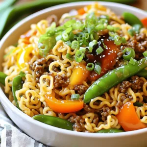 To make Mongolian Ground Beef Noodles, you need these simple ingredients: - 1 lb ground beef - 8 oz egg noodles - 1 tablespoon vegetable oil - 2 cloves garlic, minced - 1 inch fresh ginger, minced - 1 small bell pepper, thinly sliced - 1 small onion, thinly sliced - 1 cup snow peas, trimmed - 1/2 cup scallions, chopped - 1/4 cup soy sauce - 2 tablespoons hoisin sauce - 1 tablespoon sesame oil - 1 tablespoon brown sugar - 1 teaspoon crushed red pepper flakes (optional) - Salt and freshly ground black pepper, to taste You can add some fun twists to your dish. Here are a few ideas: - Sliced carrots for extra crunch - Broccoli florets for a healthy boost - Mushrooms for a savory depth - Chopped cilantro for a fresh pop - Peanuts for added texture Gather these tools before you start cooking: - Large pot for boiling noodles - Colander for draining noodles - Large skillet or wok for frying - Wooden spoon or spatula for stirring - Cutting board and knife for chopping veggies - Small bowl for mixing sauce These ingredients and tools make it easy to create a delicious family meal. Enjoy the process of cooking together! To start, bring a large pot of salted water to a boil. The salt adds flavor to the noodles. Add 8 oz of egg noodles to the pot. Cook them as directed on the package until they are al dente. This usually takes about 4 to 6 minutes. Once they are cooked, drain the noodles in a colander. Set them aside and keep them warm. Next, heat 1 tablespoon of vegetable oil in a large skillet over medium-high heat. Wait until the oil shimmers before adding 1 lb of ground beef. Cook the beef for about 5 to 7 minutes. Stir it often to break the meat apart. You want it to turn brown and cook through. Once cooked, drain any extra fat. This keeps the dish light and tasty. Now it’s time to add flavor. Keep the skillet on medium-high heat. Add 2 minced garlic cloves and 1 inch of minced fresh ginger to the beef. Sauté this mix for about 1 minute. You want the kitchen to smell great without burning the garlic. Then, add a sliced small bell pepper, a sliced small onion, and 1 cup of trimmed snow peas. Stir-fry them for 3 to 5 minutes. The veggies should stay bright and crunchy. In a small bowl, prepare the sauce. Mix together 1/4 cup of soy sauce, 2 tablespoons of hoisin sauce, 1 tablespoon of sesame oil, 1 tablespoon of brown sugar, and 1 teaspoon of crushed red pepper flakes if you like heat. Stir until the brown sugar dissolves. This sauce will add depth and sweetness to the dish. Pour your prepared sauce over the beef and veggies in the skillet. Toss everything together so the beef and vegetables get coated well. Then, add the drained egg noodles to the skillet. Stir gently to combine all the ingredients. Be careful not to break the noodles as you mix. Taste your dish and adjust the seasoning. Add salt and freshly ground black pepper as needed. Just before serving, sprinkle chopped scallions on top. This adds a fresh touch. Serve the Mongolian Thunder Noodles in large bowls. You can add more scallions and sesame seeds for garnish. Enjoy your meal warm! To keep your noodles just right, watch the clock. Cook them until they are al dente, which means they have a slight bite. This usually takes just a few minutes. If you leave them too long, they can turn mushy. After cooking, drain them right away. Rinse them quickly under cold water to stop the cooking process. This simple step helps keep them firm and ready for your dish. Seasoning is key to making your Mongolian ground beef noodles shine. Start by adding salt while cooking the noodles. This helps enhance their flavor. When you cook the beef, use both soy sauce and hoisin sauce. They add depth and sweetness. Taste as you go. You might want to add more soy sauce or a pinch of salt to balance flavors. Freshly ground black pepper also adds a nice kick. You can easily prepare this meal ahead of time. Cook the beef and veggies, then let them cool. Store them in an airtight container in the fridge. Cook the noodles fresh when you're ready to eat. This keeps them from getting soggy. You can also freeze the beef and veggie mix. Just remember to thaw it before reheating. This way, you always have a quick family meal ready to go. For the full recipe, check out the details above. {{image_4}} If you prefer a meat-free meal, tofu is a great choice. Tofu absorbs flavors well and adds a nice texture. Use firm or extra-firm tofu for the best results. Simply cut it into cubes and sauté it in oil until golden. This keeps the dish light yet satisfying. You can follow the same steps as the original recipe. Just replace the ground beef with your cooked tofu. While the soy sauce and hoisin sauce blend well, you can mix it up. Try adding oyster sauce for a deeper umami flavor. You could also use teriyaki sauce for a sweeter twist. If you want something spicy, consider adding sriracha or chili garlic sauce. These variations will keep the dish exciting and cater to your taste buds. Feel free to add more veggies to your dish. Carrots, broccoli, or baby corn work wonderfully. You can also include mushrooms for a hearty touch. Just remember to cut them into bite-sized pieces. This way, they cook evenly and blend nicely with the noodles. More veggies not only enhance flavor but also boost nutrition. They make your meal more colorful and fun! After enjoying your Mongolian Ground Beef Noodles, let the leftovers cool. Place them in an airtight container. Make sure to store them in the fridge. This way, they stay fresh for about three days. If you want to keep them longer, consider freezing. Just remember to use a freezer-safe container. When you're ready to eat the leftovers, take them out of the fridge. You can reheat them in two ways. First, use a microwave. Place the noodles in a microwave-safe bowl. Cover it with a damp paper towel. Heat for about 1-2 minutes, stirring halfway through. Second, you can use a skillet. Heat a little oil over medium heat. Add the noodles and stir until warmed through. This keeps them tasty and prevents drying out. If you want to freeze your Mongolian Ground Beef Noodles, follow these steps. First, cool the dish completely. Then, portion it into freezer-safe bags or containers. Remove as much air as possible. This helps prevent freezer burn. You can freeze them for up to three months. When you're ready to eat, thaw the noodles in the fridge overnight. Then, reheat them as mentioned above. Enjoy this easy family meal anytime! You can use ground turkey, chicken, or pork. Each will give a different taste. You can also try plant-based meats for a vegetarian option. Yes, you can. Use gluten-free soy sauce and gluten-free noodles. This way, you keep the flavors without the gluten. To add heat, use more crushed red pepper flakes. You can also add sliced jalapeños or a dash of hot sauce. You can use dried ginger, but fresh is better. Fresh ginger gives a brighter taste. If you use dried, use less, about 1/4 teaspoon. This dish is inspired by Mongolian flavors but is not traditional Mongolian food. It blends Asian tastes with Western cooking styles. You can learn more about its roots in various Asian cuisines. For the full recipe, check out the detailed cooking steps. In this post, we explored the key ingredients, step-by-step cooking process, and helpful tips for making Mongolian Ground Beef Noodles. We also discussed variations for dietary needs and safe storage methods. Remember to experiment with flavors and textures to make this dish your own. Enjoy learning and creating! This recipe can bring joy and warmth to your meals. Happy cooking!