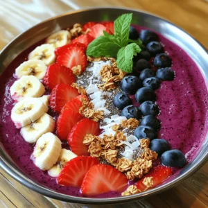 Creating the perfect Berry Bliss Smoothie Bowl starts with fresh and vibrant ingredients. Here’s what you need: - 1 cup frozen mixed berries (strawberries, blueberries, raspberries) - 1 ripe banana, sliced - 1/2 cup Greek yogurt (or dairy-free alternative) - 1/2 cup coconut milk (or preferred milk option) - 1 tablespoon honey or maple syrup (optional) - Toppings: fresh berries, additional banana slices, granola, chia seeds, shredded coconut, mint leaves Using frozen mixed berries gives your bowl a chill and a burst of flavor. The banana adds natural sweetness and creaminess. Greek yogurt not only thickens the blend but also packs a protein punch. Coconut milk makes it rich and smooth. If you like it sweeter, the honey or maple syrup works great. For toppings, the options are endless. Fresh berries and banana slices enhance the fruity taste. Granola adds crunch, while chia seeds and shredded coconut bring texture. Mint leaves not only look nice, but they also add a fresh touch. Feel free to adjust these ingredients to suit your taste. You can check the Full Recipe for exact measurements and instructions. Enjoy crafting your Berry Bliss Smoothie Bowl! - Step 1: Blend the ingredients Start by adding the frozen mixed berries, sliced banana, Greek yogurt, coconut milk, and honey or maple syrup to your blender. Blend on high until it becomes smooth and creamy. If the mix is too thick, add a little more milk. Scrape the sides as needed to get everything blended well. - Step 2: Pour and spread smoothie mixture Carefully pour the smoothie mixture into a bowl. Spread it out evenly for a nice look. You want it thick enough to hold the toppings, so keep that in mind when pouring. - Step 3: Arrange toppings artfully Now comes the fun part! Take your fresh berries, banana slices, granola, chia seeds, and shredded coconut. Start by making a line of granola in the middle. Then, place the fresh berries and banana slices around it. Sprinkle chia seeds and coconut over the top. Add mint leaves for a pop of color. This is how you create a Berry Bliss Smoothie Bowl that looks as good as it tastes! For the complete recipe, check out the Full Recipe. Achieve the right consistency For a thick and creamy smoothie bowl, use frozen mixed berries. They help create a smooth texture. If your mix is too thick, add a splash of coconut milk. Blend until it’s creamy. You want it thick enough to hold toppings without spilling. Scaling the recipe for more servings To make more servings, simply double or triple the ingredients. This recipe is easy to adjust. If you use a larger blender, you can blend everything at once. Just keep the same ratios for the best results. Ideas for customizing sweetness and flavors You can change the sweetness by adjusting the honey or maple syrup. If you like it sweeter, add more! For a new flavor, try adding vanilla extract or a splash of orange juice. Don’t shy away from mixing in different fruits, like mango or peach, to keep things fresh and exciting. For the full recipe, check out the Berry Bliss Smoothie Bowl section. Enjoy creating your perfect smoothie bowl! {{image_4}} You can mix it up with different fruits. Try mango, pineapple, or peaches for new tastes. Each fruit adds a unique flavor and texture to your bowl. Experiment and find your favorite combo! For a dairy-free option, swap Greek yogurt with coconut yogurt. Use almond or oat milk instead of coconut milk. This keeps the creamy texture while catering to your needs. Want to boost nutrition? Add nut butter like almond or peanut butter. You can also mix in protein powder for an extra kick. This makes your bowl more filling and packs in protein. You can check the Full Recipe for more details on making this delightful treat! You might have extra smoothie bowl left after making it. Here are some tips on how to store that deliciousness. - Refrigerating Unopened Portions: If you have some smoothie left, store it in an airtight container. It stays fresh for up to two days in the fridge. Keep it covered to avoid any odd smells from other foods. - Freezing Smoothie Bowls: Want to save some for later? You can freeze your smoothie bowl! Use a freezer-safe container and pour in the smoothie. Just remember to leave some space at the top. It can expand as it freezes. Smoothie bowls can last up to three months in the freezer. - Reheating Tips and Freshness Considerations: Smoothie bowls are best enjoyed cold. If you freeze it, thaw it overnight in the fridge. If it seems too thick after thawing, add a splash of milk and stir. You can also blend it again for a smoother texture. By storing your leftover Berry Bliss Smoothie Bowl correctly, you can enjoy this treat even longer! How do I make a smoothie bowl thicker? To make your smoothie bowl thicker, start with less liquid. Use frozen fruit like berries and bananas. The more frozen fruit you use, the thicker the bowl will be. You can also add Greek yogurt, which helps create a creamy texture. If it’s too runny, add a bit more fruit instead of liquid to keep it thick. Can I prepare this smoothie bowl in advance? Yes, you can prepare this smoothie bowl in advance. Blend all your ingredients and pour them into a bowl. Cover it and store it in the fridge for a few hours. However, for the best taste and texture, I recommend making it fresh. If you want to prep ahead, you can freeze the smoothie base and blend it when you’re ready to eat. What are the health benefits of berries in smoothies? Berries are packed with vitamins and antioxidants. They can help reduce inflammation and improve heart health. They also provide fiber, which is great for digestion. Adding berries to your smoothie bowl gives it a burst of flavor and color. They make your treat not just tasty, but also good for your body. This blog taught you how to make a berry bliss smoothie bowl. You learned about the key ingredients, simple steps, and smart tips. Try different fruits and toppings to make it your own. Store extras in the fridge or freezer for later. Remember, smoothies are fun and healthy, plus they can be a big treat. Enjoy your tasty creations while nourishing your body. You now have the tools to whip up a delicious smoothie bowl whenever you want!
