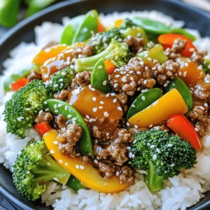 - 1 lb (450g) ground beef - 3 tablespoons honey - 4 tablespoons low-sodium soy sauce - 3 cloves garlic, finely minced - 1 teaspoon fresh ginger, grated - 2 cups mixed vegetables (such as broccoli florets, bell pepper strips, and snap peas) - 2 tablespoons vegetable oil - 1 tablespoon sesame oil - Salt and freshly cracked pepper to taste - Cooked rice or noodles (preferably jasmine rice or egg noodles) When I make this quick and easy honey garlic ground beef stir-fry, I love using fresh ingredients. The ground beef gives a rich flavor, and the honey adds a lovely sweetness. The soy sauce brings depth, while the garlic and ginger add a nice kick. You can mix any colorful veggies you like. I often use broccoli, bell peppers, and snap peas for crunch and color. For cooking, I always have vegetable oil and sesame oil ready. They help the dish shine. Use low-sodium soy sauce to keep it balanced. Don’t forget the salt and pepper; they make everything pop! To serve, I recommend fluffy jasmine rice or soft egg noodles. This dish is as fun to make as it is to eat! For the full recipe, check out the section below. Whisk together honey, soy sauce, garlic, and ginger in a bowl. This sauce adds sweet and savory flavor. Set it aside to let the flavors blend. Heat vegetable oil in a large skillet or wok over medium-high heat. The oil should shimmer to show it’s hot enough for cooking. Add the ground beef to the skillet. Cook it until browned, breaking it into small pieces. This takes about 5 to 7 minutes. Make sure it’s fully cooked. If there is extra fat, carefully drain it off. Season the beef with salt and pepper. Stir well to mix in the seasoning evenly. Push the beef to one side of the skillet. Add the mixed vegetables to the other side. Cook for 3 to 4 minutes until they are tender but still crisp. Pour the honey garlic sauce over the beef and vegetables. Stir everything together until it is well coated. Cook for 2 to 3 minutes to let the sauce thicken. Drizzle sesame oil on top of the stir-fry. This adds a rich flavor. Stir briefly to mix the oil in. Plate the hot stir-fry over rice or noodles. Enjoy your meal! For a nice touch, garnish with sesame seeds and sliced green onions. You can also serve lime wedges for extra freshness. For the Full Recipe, refer back to the ingredients section. - Use high heat for a better stir-fry texture. - Don't overcrowd the pan for even cooking. When you crank the heat, your beef gets a nice sear. This makes a big difference. A hot pan helps the beef cook fast and keeps it juicy. If you add too much food at once, it will steam instead of fry. This changes the taste and texture. So, work in batches if needed. - Substitute ground turkey or chicken for ground beef. - Add different vegetables based on seasonality. You can switch out ground beef for ground turkey or chicken. This makes a lighter dish. Feel free to add your favorite vegetables. Seasonal veggies like bell peppers and snap peas work great. You can even use broccoli or carrots. This keeps the dish fresh and exciting. - Incorporate chili flakes for added heat. - Experiment with different types of soy sauce for unique flavors. Want a kick? Add chili flakes to the mix. This brings a nice spice. You can also try different soy sauces. Regular soy sauce gives a salty taste. Tamari or coconut aminos can add depth. Don’t be afraid to play with flavors! For more ideas, check the full recipe. {{image_4}} Store leftovers in an airtight container for up to 3 days. It is best to let the stir-fry cool to room temperature before sealing it. This helps avoid condensation, which can make the food soggy. Freeze stir-fry in a freezer-safe container for up to 2 months. Make sure to leave some space in the container for the stir-fry to expand as it freezes. When you want to enjoy it later, simply thaw it overnight in the fridge before reheating. Reheat in the microwave or on the stovetop until heated through. If using a microwave, cover the dish to retain moisture. On the stovetop, add a splash of water or broth to keep the stir-fry juicy. This method helps revive the flavors and texture of the dish. You can enjoy a low-carb version of this dish. Serve it with zucchini noodles or cauliflower rice instead of regular rice. This swap cuts carbs while still giving you that comfort food feel. Zucchini noodles soak up the sauce well, and cauliflower rice adds a nice texture. Both options keep your meal light and tasty. If you prefer a plant-based option, replace the ground beef with tofu or tempeh. Tofu absorbs the honey garlic sauce well, making it flavor-packed. Tempeh adds a nutty taste and a firmer texture. Both options give you a hearty meal that’s rich in protein. You won’t miss the meat at all. For busy days, meal prep makes cooking quick. Prepare the sauce and chop the vegetables ahead of time. Store them in the fridge until you’re ready to cook. This way, you can whip up this dish in minutes. It’s a great way to save time and enjoy a home-cooked meal without the hassle. Check the Full Recipe for more tips! Yes, frozen vegetables can be used; adjust cooking time accordingly. When you use frozen veggies, they may release extra water. You want to cook them a little longer to get rid of that moisture. This way, your stir-fry stays tasty and doesn’t become soggy. Maple syrup or agave nectar can be used as a honey alternative. Both options offer sweetness, making your stir-fry delicious. If you use maple syrup, the flavor will be a bit different, but still great! You can also use brown sugar in a pinch; just dissolve it in the sauce. Add sriracha or crushed red pepper flakes for extra heat. Both options will add a nice kick to the dish. Start with a small amount and taste. You can always add more if you want it spicier. Just be careful not to overdo it! Stir-fry is best enjoyed fresh, but can be prepped in advance to save time. You can chop your veggies and mix the sauce ahead of time. Store them in the fridge until you’re ready to cook. This makes dinner quick and easy on busy nights. Check out the Full Recipe for all the details! This recipe uses simple ingredients to create a tasty stir-fry. You learned about the key components and step-by-step cooking methods. We covered tips for cooking and storage to keep your dish fresh. You can make it your own with different meats and vegetables. Try the variations to suit your taste or dietary needs. Whether you love the original or want to mix it up, this dish is fun to prepare. Enjoy sharing this easy recipe with family and friends.