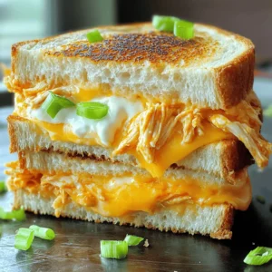 To make a Buffalo Chicken Grilled Cheese, you need some tasty ingredients. Here’s what you’ll need: - 2 slices of thick-cut bread (sourdough or ciabatta recommended) - 1 cup cooked shredded chicken - 1/4 cup buffalo sauce - 1 cup shredded sharp cheddar cheese - 1/4 cup softened cream cheese - 2 tablespoons butter - Optional add-ins: blue cheese crumbles, sliced green onions These ingredients make a great mix of flavors. The chicken gives protein, while the buffalo sauce adds spice. The cheeses create a creamy texture, and the bread holds everything together. You can also add blue cheese or green onions to make it even better. For the full recipe, check out the detailed cooking steps! First, take your cooked chicken and shred it. Place it in a mixing bowl. Now, pour in the buffalo sauce. Mix it well until every piece of chicken is covered. If you like it spicier, add more buffalo sauce. If you prefer it milder, use less. This mixture packs a punch and gives great flavor to your sandwich. Next, grab another bowl for the cream cheese. Soften the cream cheese first, then add half of the shredded cheddar cheese. Mix them together until you get a smooth blend. This creamy layer will add richness to your grilled cheese. Now it’s time to cook! Heat a skillet over medium heat. Add one tablespoon of butter and let it melt. Take one slice of thick-cut bread and spread the cream cheese mixture on one side. Cover the entire slice for full flavor. On the plain side, pile on the buffalo chicken mixture. Sprinkle the rest of the cheddar cheese on top. If you want, add blue cheese crumbles for extra flavor. Top it all with the second slice of bread, cream cheese side down. Place the sandwich into the hot skillet. Cook for about 3-4 minutes on each side. Flip it carefully to keep it intact. After about two minutes, add the other tablespoon of butter to the skillet. This helps to make the bread golden brown and crispy. When both sides are perfectly brown and the cheese is melty, take it out of the skillet. Let it cool for a minute before slicing. Cut it in half for easy eating. You can serve it with extra buffalo sauce for dipping or a fresh salad on the side. This meal is all about comfort and flavor. Enjoy your Buffalo Chicken Grilled Cheese! For more details, check the Full Recipe. To make a great Buffalo chicken grilled cheese, choose thick-cut bread. Sourdough and ciabatta work well. Their texture holds up to the filling. A thicker slice means more crunch and flavor. Thin bread may get soggy. Go for bread that has a nice crust. It adds to the overall taste and feel. For the best flavor, use a mix of cheeses. Sharp cheddar brings a strong taste. Cream cheese adds creaminess. You can also try mozzarella for stretchiness. If you love blue cheese, sprinkle some in for a punch. Mixing these cheeses makes each bite exciting. The right cooking time and heat matter a lot. Start with medium heat. This helps the cheese melt without burning the bread. Cook each side for about 3-4 minutes. If it browns too fast, lower the heat. Adding butter halfway through boosts the crunch. It creates a golden crust that feels amazing to bite into. {{image_4}} If you want to amp up the heat, try adding more buffalo sauce or some hot peppers. This gives your grilled cheese a fiery kick. Sliced jalapeños or banana peppers work well. Mix them into the buffalo chicken filling for a spicy surprise. You can even sprinkle extra hot sauce on the finished sandwich if you dare! For a tasty vegetarian twist, swap the chicken for roasted cauliflower or mushrooms. Cauliflower gives a nice texture and absorbs flavor well. Simply roast the cauliflower with some buffalo sauce until it's tender. Mushrooms add a rich, earthy taste. Both options make a hearty grilled cheese that everyone can enjoy! Get creative with your choice of cheese and spreads. Try mixing in different cheeses like pepper jack for heat or gouda for a smoky flavor. You can also spread some pesto or ranch dressing inside the sandwich for extra zest. These small changes can elevate your buffalo chicken grilled cheese into a gourmet treat. For the complete recipe, check the Full Recipe section. To keep your Buffalo Chicken Grilled Cheese fresh, wrap it well in plastic wrap or aluminum foil. Store it in the refrigerator. The sandwich tastes best within two days. This helps maintain its flavor and texture. If you leave it out too long, it can get soggy or dry. When you want to enjoy leftovers, use a skillet for the best results. Heat the skillet over low to medium heat. Place the sandwich in the skillet and cover it with a lid. This helps the cheese melt while keeping the bread crunchy. Heat for about 3-4 minutes on each side. You can add a bit of butter in the pan for extra crispiness. To freeze your sandwich, wrap it tightly in plastic wrap, then in foil. Make sure to remove as much air as possible. This way, it won’t get freezer burn. When you are ready to eat it, thaw it in the fridge overnight. After thawing, reheat it in a skillet to get that perfect crunch again. Yes, you can use store-bought buffalo chicken. It saves time and effort. However, the flavor may not match homemade. Store-bought often has added preservatives. Make sure to check the label for quality. If you choose this route, adjust the buffalo sauce to match your spice level. You can always add more sauce if needed. The best cheese for grilled cheese is sharp cheddar. It melts well and offers a strong flavor. Other great options include mozzarella and gouda. These cheeses add creaminess and taste. Mixing different cheeses can enhance the flavor even more. Try adding some blue cheese for a tangy twist. This creates a rich, layered taste that pairs well with buffalo chicken. To prevent sogginess, choose thick-cut bread like sourdough. It holds up better under heat. Use a good amount of butter on the outside. This helps create a crispy crust. Avoid overloading the sandwich with filling. This can trap moisture inside. Cooking on medium heat ensures even cooking without burning. Flip the sandwich gently to maintain its shape. You’ve learned how to make a delicious buffalo chicken grilled cheese sandwich. We covered the best ingredients, from thick-cut bread to creamy cheese. I shared tips on achieving the perfect crunch and your options for variations. Remember, you can customize this recipe to fit your taste. Whether you go spicy or vegetarian, enjoy the fun of cooking! Now, you've got all the tools to create a tasty meal. Happy grilling!