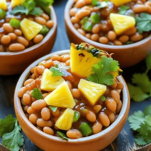 - 2 cups cooked navy beans (or canned beans, rinsed and drained) - 1 cup fresh pineapple chunks (or canned pineapple, drained) - 1 medium onion, finely diced - 1 green bell pepper, finely diced - 2 cloves garlic, minced - 1/4 cup brown sugar - 1/4 cup ketchup - 2 tablespoons soy sauce - 1 teaspoon mustard (yellow or Dijon) - 1 teaspoon smoked paprika - 1/2 teaspoon freshly ground black pepper - 1 tablespoon olive oil - Salt to taste - Other beans or legumes (variation options) - Different types of mustard (for flavor enhancement) - Baking dish (9x13-inch recommended) - Large skillet - Mixing bowl - Aluminum foil When I make homemade pineapple baked beans, I love to keep my ingredients fresh. The sweet pineapple pairs well with savory beans. You can use canned beans if you want to save time. Just remember to rinse them well. The onion and green bell pepper add a nice crunch. They give the dish depth and flavor. Always dice them finely for even cooking. Garlic brings an amazing aroma, so don't skip it! For the sauce, brown sugar adds sweetness, while ketchup gives it a rich taste. The soy sauce gives a nice umami kick. I usually use yellow mustard, but Dijon works too. A hint of smoked paprika adds a warm, smoky flavor. Don't forget the black pepper for a little heat! You can switch up the beans if you want. Kidney beans or black beans also work great. Different mustards can change the taste too. Try spicy mustard for a bold twist. To prepare, you need a few tools. A good baking dish helps the beans cook evenly. A large skillet is necessary for sautéing the veggies. A mixing bowl makes combining all the ingredients easy. Aluminum foil helps keep the dish moist while it bakes. Check out the full recipe for more details on how to bring this dish to life! 1. Preheat your oven to 350°F (175°C). This step is critical. A hot oven cooks your beans evenly and helps them develop flavor. 2. Sauté the vegetables. In a large skillet, add one tablespoon of olive oil and heat over medium. Once hot, add 1 medium onion and 1 green bell pepper, both finely diced. Cook for about 5-7 minutes. Stir them often. You want them soft and a bit see-through. 3. Add garlic. Once the veggies are ready, stir in 2 cloves of minced garlic. Sauté for another minute. The garlic should smell great, but don't let it burn. 1. Combine all the ingredients. In a large mixing bowl, add 2 cups of cooked navy beans. If you use canned beans, rinse and drain them first. Then, add your sautéed vegetables and 1 cup of fresh pineapple chunks. 2. Mix in the sauces. Add 1/4 cup of brown sugar, 1/4 cup of ketchup, 2 tablespoons of soy sauce, 1 teaspoon of mustard, 1 teaspoon of smoked paprika, and 1/2 teaspoon of black pepper. Don’t forget to add salt to taste. Mix everything well until fully combined. 1. Transfer the mixture. Carefully pour the mixed ingredients into a greased 9x13-inch baking dish. Spread it out evenly. This helps all parts cook at the same time. 2. Cover and bake. Take aluminum foil and cover the dish tightly. Place it in your preheated oven. Bake for 30 minutes. This allows the flavors to meld nicely. 3. Final baking. After 30 minutes, remove the foil. Let it bake for another 15-20 minutes. This step gets the top nice and caramelized, adding a sweet touch to your dish. These steps create a delicious homemade pineapple baked beans dish that brings a tropical twist to your table. For the full recipe, don’t forget to check out the detailed instructions! To get the best flavor balance in your pineapple baked beans, use fresh ingredients. Fresh pineapple adds a bright taste. Pair it with sweet and savory flavors like brown sugar and soy sauce. This mix keeps your dish exciting. Sautéing vegetables before baking is key. It brings out their natural sweetness. Start by heating olive oil in a skillet. Add diced onion and green bell pepper. Cook them until they are soft and clear. This step makes a big difference in flavor. For a beautiful presentation, serve baked beans in individual bowls. Add fresh pineapple wedges on top. Sprinkle chopped cilantro or parsley for color. This adds a tropical vibe to your dish. When pairing drinks, try iced tea or a light beer. They complement the sweetness of the baked beans. Serve with grilled meats or a fresh salad for a complete meal. One common mistake is overcooking or undercooking beans. If you use dried beans, soak them well. Cook them until tender but not mushy. Canned beans should be rinsed and drained for the best taste. Another mistake is skipping the preheating step. Preheating your oven allows even cooking. It helps the flavors mix well during baking. Always remember to set your oven to the right temperature before you start. {{image_4}} You can make this dish even more exciting with different fruit. Try adding mango or peach. These fruits add a sweet twist to the beans. You can also spice things up! Adding red pepper flakes gives a nice kick. Just a pinch can change the whole dish. Experiment and find what flavors you love. If you want a vegan version, it's easy to swap out a few ingredients. Use maple syrup instead of brown sugar for sweetness. You can use tamari instead of soy sauce for a gluten-free option. These changes keep the taste great while fitting your diet. Don’t worry if you don’t have navy beans. You can use black beans or pinto beans instead. Each gives a unique flavor and texture. For sweetener, try honey or agave syrup. Both work well in this recipe. These simple swaps can help you make this dish your own. Feel free to check out the Full Recipe for more tips! After you make your homemade pineapple baked beans, let them cool. This helps keep their taste and texture. Once cooled, place the beans in an airtight container. Store them in the fridge. They can last about 3 to 5 days. For longer storage, freezing is a great option. First, let the beans cool completely. Then, transfer them to a freezer-safe container. Leave some space at the top, as the beans will expand when frozen. You can freeze them for up to 3 months. To reheat, first thaw the beans in the fridge overnight. Then, heat them in a pot over medium heat. Stir often until warm. If they seem dry, add a splash of water or broth. You can also reheat them in the microwave. Refrigerated baked beans stay good for about 3 to 5 days. If frozen, they will keep their best flavor for about 3 months. After that, they may lose some taste but are still safe to eat. Enjoy your homemade pineapple baked beans while they are fresh! To make Homemade Pineapple Baked Beans, follow these key steps: 1. Preheat your oven to 350°F (175°C). 2. In a skillet, heat olive oil. Sauté diced onion and green bell pepper until soft. 3. Add minced garlic and cook for one more minute. 4. In a bowl, mix cooked navy beans, sautéed veggies, pineapple, brown sugar, ketchup, soy sauce, mustard, smoked paprika, and black pepper. Add salt to taste. 5. Transfer to a greased baking dish. Cover with foil and bake for 30 minutes. 6. Remove the foil and bake for another 15-20 minutes to caramelize the top. This method gives you rich flavors and a sweet twist. For the full recipe, check the earlier section. Yes, you can use canned beans. They save time and are easy to use. - Rinse and drain the canned beans before mixing them in the recipe. - Canned beans are soft, which means no need to cook them beforehand. - They help speed up the process, making this dish quick and simple. Using canned beans also means you can enjoy this dish anytime. Pineapple Baked Beans pair well with many dishes. Here are some ideas: - Serve them with grilled chicken or pork for a tasty meal. - Pair with cornbread for a southern twist. - Enjoy with a fresh salad for a light side. - Serve as a side dish at BBQs or potlucks. These beans add a sweet and savory touch to any meal. Storing leftovers is easy to keep them fresh: - Let the beans cool completely before storing. - Place them in an airtight container and refrigerate. - They can last up to 4 days in the fridge. For long-term storage: - Freeze them in a freezer-safe container. - They can stay good for up to 3 months. - Thaw in the fridge overnight before reheating. This way, you can enjoy your delicious beans later! This recipe for pineapple baked beans offers a tasty mix of flavors and easy steps. You learned about the ingredients, how to prepare, and tips to perfect your dish. Making tasty desserts and avoiding common mistakes is key. Remember, feel free to try different fruits or spices for fun! Store any leftovers properly to keep them fresh. Enjoy your cooking adventure, and impress your friends and family with this delicious dish!