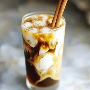 To make the Honey Cinnamon Cold Brew, gather these simple ingredients: - 1 cup coarsely ground coffee - 4 cups cold water - 2 tablespoons honey - 1 teaspoon ground cinnamon - 1/2 cup milk or dairy-free alternative (like almond milk or oat milk) - Ice cubes - Cinnamon sticks (for garnish, if you like) If honey isn't your thing, try other sweeteners. Maple syrup works well and adds a nice flavor. You can also use agave syrup for a lighter taste. For a low-calorie option, consider stevia or monk fruit sweetener. Both mix well and keep it sweet without the calories. For the best taste, use a medium to dark roast coffee. These blends bring out rich flavors. Look for coffee labeled as "cold brew" for a smoother taste. Single-origin beans can also add unique notes. Experiment to find your favorite! To make the coffee concentrate, start with 1 cup of coarsely ground coffee. Place it in a large pitcher or jar. Add 4 cups of cold water to the coffee grounds. Stir gently to help all the coffee soak in the water. This step is crucial for a smooth flavor. Cover your pitcher with a lid or plastic wrap. Place it in the refrigerator. Let it steep for 12 to 24 hours. The longer it steeps, the bolder the taste. If you want a strong coffee flavor, aim for the full 24 hours. After steeping, you need to strain the coffee concentrate. Use a fine-mesh sieve or a coffee filter. Pour the coffee through the sieve to separate the liquid from the grounds. Discard the coffee grounds, and keep the liquid. This is your cold brew base. To get the right strength, steep your coffee for 12 to 24 hours. A longer steep gives a bolder taste. If you like a lighter drink, stick to 12 hours. For a strong flavor, aim for 24 hours. Always taste the coffee after steeping. Adjust the strength based on your own preference. Mix honey and cinnamon in a small bowl before adding them to your drink. This step helps blend the flavors well. If your honey is thick, warm it gently in the microwave. This makes mixing easier. When you combine cold brew and honey-cinnamon, use a tall glass for easy stirring. Always taste your drink before serving. You can add more honey or cinnamon if needed. Serve your cold brew in clear glasses. This shows off the rich color and makes it look appealing. Adding a cinnamon stick not only looks nice but adds extra flavor too. Pair your drink with a light snack, like a cookie or a muffin. This makes for a delightful coffee break. Enjoy your beautiful and tasty creation! {{image_4}} To make an iced honey cinnamon latte, start with cold brew. Use the same honey-cinnamon mix. In a tall glass, pour the cold brew over ice. Add milk and stir. For a twist, try using whipped cream on top. This adds sweetness and creaminess. If you're avoiding dairy, try almond or oat milk. Both options blend well with honey and cinnamon. They give a creamy texture without dairy. You can also use coconut milk for a tropical twist. Each choice adds a unique flavor to your drink. Want to spice up your drink? Add a splash of vanilla extract. It enhances the sweet notes of honey. Nutmeg is another great choice. Just a pinch can add warmth and depth. You can even mix in cocoa powder for a mocha touch. Experiment with these flavors to find your favorite! To store your cold brew concentrate, keep it in a glass jar. Make sure the jar has a tight lid. This helps keep the coffee fresh and tasty. You can store it in the refrigerator for up to two weeks. Always use a clean spoon to avoid any germs. If you notice any strange smells or tastes, it’s best to toss it out. The honey and cinnamon mixture lasts about two weeks in the fridge. Store it in a small, sealed container. If you see any changes in color or texture, it is safer to discard it. Honey is a natural preservative but does lose flavor over time. Always check before using. You can reuse coffee grounds in several ways. First, they work well for gardening. They add nutrients to your soil. Second, you can use them as a natural scrub for your skin. Just mix them with some coconut oil for a gentle exfoliant. Lastly, consider drying them out and using them for crafts or as odor absorbers in your fridge. Remember, do not reuse them for cold brew, as they will lose flavor. The best coffee for cold brew is coarsely ground coffee. Look for a blend that is smooth and rich. Dark roasts are popular for their bold flavor. Medium roasts work well too, offering a balanced taste. Always choose fresh coffee beans for the best results. Grind them right before brewing for top flavor. Yes, you can use any milk you like! Dairy-free options include almond milk, oat milk, or coconut milk. Each adds a unique flavor. Almond milk gives a nutty taste, while oat milk is creamy and smooth. If you prefer cow's milk, choose whole, skim, or any fat level you enjoy. The honey cinnamon mixture can last about two weeks if stored properly. Keep it in a sealed container in the fridge. If it thickens, warm it slightly to make mixing easier. Always check for changes in smell or color before using. If it looks off, it's best to toss it. Honey and cinnamon offer many health benefits. Honey can boost energy and soothe sore throats. It has antioxidants that help fight free radicals. Cinnamon can lower blood sugar and reduce inflammation. Together, they may improve heart health and digestion. Enjoy these in your drink for a tasty health boost! This blog post covered how to craft a delicious honey cinnamon cold brew. We discussed the key ingredients, brewing methods, and ways to store your concentrate. I shared tips for perfecting strength and presentation. You also learned about fun variations like iced drinks and dairy-free options. Remember, creating your drink is about enjoying the process. Experiment with flavors and find what suits you best. Happy brewing!