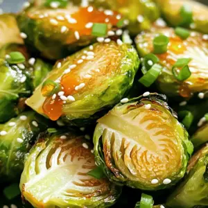 - 1 lb Brussels sprouts - 3 tablespoons extra-virgin olive oil - 2 tablespoons pure honey - 2 tablespoons Sriracha sauce - 1 tablespoon low-sodium soy sauce - 1 teaspoon garlic powder - Salt and freshly cracked black pepper - 2 tablespoons sesame seeds (optional) - Freshly chopped green onions for garnish When I make Honey Sriracha Brussels sprouts, I start with fresh, clean Brussels sprouts. They bring a nice crunch and flavor. I cut them in half, which helps them cook evenly. Next, I use extra-virgin olive oil to coat the sprouts. It gives a great base for the glaze. Honey adds a lovely sweetness, balancing the spicy Sriracha. The soy sauce brings depth, making each bite bold and tasty. I also sprinkle garlic powder, salt, and pepper for extra flavor. Those small touches really make a difference. If I want to add some crunch, I include sesame seeds on top. The green onions finish the dish with color and a fresh taste. These ingredients blend together to create a dish that is not only crunchy but also deeply flavorful. Each bite of these Brussels sprouts is a mix of sweet, spicy, and savory. - Preheat oven to 400°F (200°C). - Clean and halve the Brussels sprouts. Start by getting your oven nice and hot. This step is key for crispy Brussels sprouts. While the oven heats, take your Brussels sprouts. Rinse them under cool water to remove dirt. Then, slice each sprout in half. This helps them cook evenly and get that nice crunch. - Combine olive oil, garlic powder, salt, and pepper. - Toss Brussels sprouts until evenly coated. In a large bowl, add the halved Brussels sprouts. Pour in three tablespoons of olive oil. Add one teaspoon of garlic powder, and sprinkle some salt and black pepper. Now, use your hands to toss them well. Make sure every sprout is coated with oil and spices. This will add great flavor. - Roast Brussels sprouts for 20-25 minutes, tossing halfway. - Prepare the honey Sriracha glaze. - Drizzle glaze over roasted sprouts and return to oven for an additional 5 minutes. Place the seasoned Brussels sprouts on a baking sheet. Spread them out so they are not crowded. Roast them in the oven for 20 to 25 minutes. Halfway through, give them a good toss. This ensures they cook evenly. While they roast, it’s time to make the glaze. In a small pot, mix two tablespoons of honey, two tablespoons of Sriracha, and one tablespoon of soy sauce. Heat this mixture on low for about three minutes. Stir gently until it blends well. After roasting, take the Brussels sprouts out. Drizzle your honey Sriracha glaze over them. Toss them again gently to coat every sprout. Return them to the oven for five more minutes. This step makes the glaze sticky and flavorful. Enjoy the aroma in your kitchen! To get crispy edges on your Brussels sprouts, follow these tips: - Use high heat: Roasting at 400°F (200°C) helps them caramelize. - Toss halfway: Flip the sprouts midway through cooking. This gives them even browning. - Don't overcrowd the pan: Lay out the sprouts in a single layer. When they have space, they roast better. Even spacing on the baking sheet is key. It allows hot air to circulate. This circulation creates that nice crunch. If they touch, they steam instead of roast. So, give them room to shine! Feel free to adjust the glaze to suit your taste. Here are some ideas: - Change sweetness: Add more honey for a sweeter kick, or less for a milder taste. - Adjust spiciness: If you like it hot, add more Sriracha. For a milder version, reduce the amount. - Try different sauces: Swap Sriracha for another hot sauce, like chili garlic sauce, for a twist. Experimenting with flavors can lead to new favorites. Don’t be afraid to get creative! Presentation makes a big difference. Here are some tips to serve your Brussels sprouts: - Use a nice platter: Serving on a beautiful dish makes the meal feel special. - Drizzle extra glaze: Pour any leftover glaze from the baking sheet over the top for added flavor. - Add garnishes: Sprinkle extra sesame seeds and chopped green onions for color. Pair your Honey Sriracha Brussels sprouts with grilled chicken or fish. They also go well with rice dishes. Enjoy the perfect blend of flavors and textures! {{image_4}} You can switch up the veggies in this dish. Try using cauliflower or broccoli instead of Brussels sprouts. Both work great with the honey Sriracha glaze. When it comes to sweeteners, explore different types of honey. Clover honey has a mild taste. Buckwheat honey adds a rich flavor. You can also use maple syrup if you want a vegan-friendly option. For extra crunch, add nuts like almonds or cashews. Toast them lightly before mixing them in for a nutty flavor. Fruits can add a nice contrast. Try adding diced apples or pomegranate seeds for some sweetness. They will balance the heat of the Sriracha. To make this dish vegan, swap the honey for agave syrup. It will give you the same sweetness without the bee product. For a gluten-free version, check your soy sauce. Use tamari instead, which is gluten-free. Always read labels to ensure your ingredients are safe. To keep your Honey Sriracha Brussels sprouts fresh, store them in the fridge. Place them in an airtight container. This helps maintain their flavor and texture. They will stay fresh for up to three days. After that, they may lose their crispness and taste. When you want to enjoy leftovers, reheating is key. The best way is to use the oven. Preheat it to 350°F (175°C). Spread the Brussels sprouts on a baking sheet. Bake for about 10-15 minutes. This method keeps them crispy. You can also use an air fryer. Set it to 350°F (175°C) and cook for about 5-7 minutes. If you want to freeze Brussels sprouts, first roast them without the glaze. Let them cool completely. Then, store them in freezer-safe bags. Remove as much air as possible to prevent freezer burn. They can last up to three months in the freezer. When you're ready to eat, thaw them overnight in the fridge. Reheat them in the oven or air fryer for best results. Yes, you can prepare Honey Sriracha Brussels Sprouts before serving. Start by roasting the Brussels sprouts as directed. After they cool, store them in an airtight container in the fridge. They will stay fresh for about 3 days. When you are ready to eat, reheat them in the oven. Preheat to 350°F (175°C) and bake for about 10 minutes. This keeps them crispy. If you want to warm them up faster, you can use a microwave. Just be careful, as they might lose some crunch. Honey Sriracha Brussels Sprouts pair well with many dishes. Here are some ideas: - Grilled chicken or shrimp - Beef stir-fry - Baked salmon - Quinoa or rice - A green salad for a fresh touch These options create a nice balance of flavors and textures on your plate. If you lack Sriracha, don't worry! You can try other sauces. Here are some alternatives: - Chili garlic sauce for heat and flavor - Hot sauce like Frank's RedHot for a different kick - Sweet chili sauce for a milder, sweeter taste Each option gives a unique twist to the dish. Adjust the amount based on your taste preference. Honey Sriracha Brussels sprouts are easy and fun to make. You learned how to prepare and roast them, ensuring the right flavors pop. Try adding your own spin to the recipe. Remember, you can switch up the ingredients for your taste. Store leftovers well to enjoy later. With these tips, your sprouts will impress friends and family. Enjoy your tasty dish and the fun of cooking!