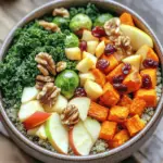 - 1 cup quinoa - 2 cups vegetable broth - 1 medium sweet potato - 1 cup Brussels sprouts - 1 cup kale - 1 crisp apple - ½ cup dried cranberries - ½ cup walnuts - 2 tablespoons olive oil - 1 teaspoon ground cinnamon - 1 tablespoon maple syrup (optional) - Juice of 1 fresh lemon - Salt and pepper Each serving has about 400 calories. This bowl is rich in fiber, protein, and healthy fats. The quinoa gives you protein, while the sweet potato adds vitamins. Brussels sprouts bring antioxidants, and kale is packed with nutrients. Apples add a touch of sweetness, and walnuts give crunch and healthy fats. Dried cranberries add flavor and antioxidants. This bowl fuels your body and supports your health. Preheating your oven helps cook food evenly. Set your oven to 400°F (200°C). This heat is perfect for roasting vegetables. To cook fluffy quinoa, rinse it well under cold water. In a medium pot, mix 1 cup of quinoa with 2 cups of vegetable broth. Bring it to a boil over medium-high heat. Once boiling, lower the heat to simmer. Cover the pot and let it cook for about 15 minutes. All the liquid should absorb when it’s ready. After cooking, let it sit covered for 5 more minutes. This step helps make it fluffy. While the quinoa cooks, prepare the veggies. Peel and cut the sweet potato into 1-inch cubes. Trim and halve the Brussels sprouts. On a large baking sheet, mix the sweet potato and Brussels sprouts. Drizzle with olive oil and sprinkle ground cinnamon, salt, and pepper on top. Toss them well to coat evenly. Roast the veggies for 25-30 minutes. Check for doneness by ensuring the sweet potatoes are fork-tender and starting to caramelize. Stir them halfway through for even cooking. In a large bowl, combine the cooked quinoa, roasted sweet potatoes, Brussels sprouts, chopped kale, diced apple, dried cranberries, and chopped walnuts. Drizzle fresh lemon juice over the mixture. If you like, add maple syrup for sweetness. Toss everything gently to mix without breaking the veggies. Scoop the warm mixture into individual bowls. For a nice touch, top with extra walnuts and cranberries. This adds crunch and color to your meal. Enjoy every bite of this nourishing dish! To make your Autumn Harvest Buddha Bowl shine, avoid a few common mistakes: - Overcooking the quinoa: This can make it mushy. Keep an eye on the time. - Not seasoning enough: A little salt and pepper can boost flavors. - Skipping the lemon juice: This adds brightness and balances the sweetness. Enhance flavors with these tricks: - Use fresh herbs like parsley or cilantro for a pop of flavor. - Add a sprinkle of feta cheese for a creamy touch. - Try roasting the vegetables longer for more caramelization. You can easily add protein to your bowl. Here are some great options: - Chickpeas: Roast them for crunch. - Tofu: Marinate and bake for extra flavor. - Grilled chicken: For a heartier option. Feel free to swap in different seasonal veggies: - Butternut squash: Sweet and creamy, perfect for fall. - Beets: Earthy and colorful, they add great texture. - Carrots: Sweet and crunchy, they work well roasted. To dress up your Buddha bowl, consider these dressings: - Balsamic vinaigrette: Tangy and sweet, it complements the dish well. - Tahini dressing: Rich and nutty, it adds creaminess. - Honey mustard dressing: Sweet and zesty, it brings a nice kick. For side dishes, I recommend: - A light soup: Like pumpkin or lentil, perfect for fall. - A simple green salad: Adds freshness and crunch. - Whole grain bread: Great for dipping and soaking up flavors. {{image_4}} You can change up the vegetables in your Autumn Harvest Buddha Bowl based on what’s in season. Try using butternut squash or carrots instead of sweet potatoes. These options also add nice sweetness and texture. For greens, use spinach or Swiss chard if kale is not available. You can also swap out Brussels sprouts for cauliflower or broccoli. When it comes to fruits, think about using pears instead of apples for a softer taste. You can also add pomegranate seeds for a pop of color and flavor. Each swap gives a new twist to the dish, keeping it fresh and exciting. If you need gluten-free options, use rice or millet in place of quinoa. Both add a great base to your bowl without gluten. For those who follow a vegan diet, simply skip the maple syrup or replace it with agave nectar. This keeps the bowl sweet without using animal products. If you want to make it vegetarian, just avoid adding meats. Instead, add chickpeas or tofu for protein. These ingredients make your bowl hearty and filling while still being meat-free. Buddha bowls can be served hot or cold, depending on your preference. If you want a warm meal, serve it right after mixing the ingredients. If you prefer a cold dish, let it chill in the fridge for a bit. These bowls are perfect for meal prep. You can make a big batch and store it in containers. They work great for potlucks too. Just pack them up and share with friends. The colors and flavors always impress! To keep your Autumn Harvest Buddha Bowl fresh, follow these tips: - Cool the bowl: Let it cool completely before storing. - Use airtight containers: Glass or plastic containers work well. - Separate ingredients: Store the quinoa and veggies apart from the dressing. This helps keep each component fresh and tasty. When you're ready to enjoy leftovers, use these safe methods: - Microwave: Place in a bowl and cover loosely. Heat for 1-2 minutes. - Stovetop: Heat in a skillet over low heat. Add a splash of water to steam. To keep the texture and flavor, do not overheat. Stir gently while warming. Some ingredients freeze well, while others do not. Here’s how to do it right: - Best for freezing: Quinoa and roasted sweet potatoes freeze well. - Not ideal for freezing: Fresh kale, apples, and walnuts lose texture. To freeze, place cooled quinoa and sweet potatoes in freezer bags. Remove excess air and seal. Thaw in the fridge overnight before reheating. To make your Buddha bowl vegan, you can swap out certain ingredients. Use vegetable broth instead of chicken broth. For a protein boost, add chickpeas or tofu. You can also skip the maple syrup if you prefer. Most ingredients are already vegan, like quinoa, sweet potatoes, and kale. Yes, you can use other grains! Good options include brown rice, farro, or barley. Each grain has a unique texture and flavor. Adjust cooking times as needed. For example, brown rice takes longer to cook than quinoa. You can pair your Buddha bowl with a variety of sides. Grilled tofu or tempeh adds protein. A simple green salad or roasted veggies work well too. If you want something warm, serve a cup of soup alongside. The total time is about 50 minutes. You need 15 minutes for prep and 35 minutes for cooking. Cooking the quinoa takes about 20 minutes, while roasting the veggies takes 25-30 minutes. Yes, you can meal prep this dish! Cook the quinoa and roast the veggies in advance. Store them in the fridge for up to three days. Mix everything together just before serving for the best taste and texture. The Autumn Harvest Buddha Bowl offers a taste of seasonal flavors and healthy ingredients. We covered everything from the core ingredients, like quinoa and sweet potato, to easy cooking and serving tips. Remember, customize it to fit your tastes and dietary needs. Keep experimenting with new flavors and ingredients. Whether you enjoy it warm or cold, this bowl is a versatile meal. Enjoy creating a dish that nourishes both body and spirit.