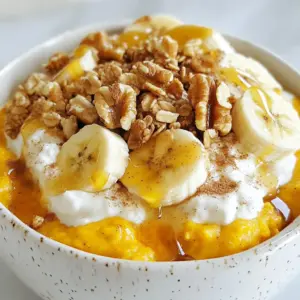 - 1 cup cottage cheese - ½ cup pure pumpkin puree - 1 tablespoon maple syrup (or honey as a substitute) - ½ teaspoon ground cinnamon - ¼ teaspoon ground nutmeg - 1 tablespoon chia seeds - 1 ripe banana, sliced - 2 tablespoons granola - A handful of chopped walnuts or pecans - A pinch of salt For this Pumpkin Cottage Cheese Breakfast Bowl, you need simple ingredients. Each one adds flavor and nutrition. First, grab cottage cheese. It gives a creamy base and packs protein. Then, use pure pumpkin puree. This adds a rich flavor and vibrant color. You can use canned or fresh pumpkin. Next, add maple syrup or honey for sweetness. The ground cinnamon and ground nutmeg bring warmth and spice. They make this bowl cozy and inviting. Don’t forget the chia seeds. They boost nutrition and add a fun texture. A ripe banana sliced adds natural sweetness and creaminess. Top your bowl with granola for a crunchy bite. Finally, chopped walnuts or pecans give a nutty flavor, plus healthy fats. A pinch of salt helps balance all the flavors. These ingredients create a delicious, filling breakfast. You can mix and match to suit your taste. {{ingredient_image_2}} Start by adding the cottage cheese and pumpkin puree into a medium mixing bowl. Use a spatula or spoon to stir well. Mix until the two combine into a smooth and creamy blend. Ensure there are no lumps left. This base is the heart of your breakfast bowl. Now, sprinkle in the maple syrup, ground cinnamon, and ground nutmeg. Add a pinch of salt to enhance the flavors. Mix everything together thoroughly. Then, fold in the chia seeds for added nutrition. These tiny seeds pack a big punch with fiber and omega-3s. Carefully spoon the creamy pumpkin cottage cheese blend into a serving bowl. Now comes the fun part! Arrange the sliced banana artfully on top. Add a handful of granola for crunch, and sprinkle the chopped nuts for extra texture. If you like, drizzle more maple syrup on top for sweetness. Enjoy your colorful and tasty breakfast! You can adjust the sweetness in your bowl. If you like it sweeter, add more maple syrup. You might also try honey as a substitute. Both options work great! For toppings, feel free to mix things up. Instead of just granola, you could use nuts or seeds. Dried fruits can add a nice touch too. Try adding sliced apples for a crunchy twist. You can even sprinkle some coconut flakes on top for extra flavor! The way you present your dish matters. Arrange the banana slices in a fan shape. This makes your bowl look lovely and inviting. A sprinkle of cinnamon on top adds not just flavor but also a great aroma. This simple touch makes your breakfast bowl special. Plus, it’s an easy way to impress anyone who sees it! Pro Tips Use Fresh Pumpkin: If you have the time, consider using fresh pumpkin instead of canned for a more vibrant flavor. Roast the pumpkin until tender, then puree it for your bowl. Sweetness Balance: Adjust the sweetness based on your preference. Taste the mixture before adding more maple syrup or honey to ensure it meets your liking. Chia Seed Benefits: Chia seeds not only add nutrition but also help thicken the mixture. Let the bowl sit for a few minutes after mixing, allowing the chia seeds to absorb moisture and create a creamier texture. Nut Variations: Feel free to experiment with different nuts! Almonds or pistachios can add a unique flavor and crunch to your breakfast bowl. {{image_4}} You can switch up your pumpkin cottage cheese bowl with seasonal fruits. Apples and pears work great in fall. Just slice them thin and add them on top. They add crunch and freshness. You can also add a dollop of yogurt or nut butter. Greek yogurt gives a creamy texture. Nut butter adds healthy fats and more flavor. If you need dairy-free options, try coconut yogurt or almond milk yogurt. These can be great substitutes for cottage cheese. They keep the bowl creamy. For those on a keto diet, switch the maple syrup for a low-carb sweetener. Stevia or erythritol are good options. They add sweetness without the carbs. To keep your pumpkin cottage cheese bowl fresh, store it in an airtight container. This method helps prevent odors from other foods in the fridge. Make sure to seal the lid tightly. Leftovers can stay fresh for up to three days. After that, the taste and texture may decline. When you're ready to enjoy your leftovers, reheat gently. Use the microwave for about 30 seconds. Stir halfway through to ensure even heating. Avoid overheating, as it can change the texture and make it watery. If you like, add a splash of milk or extra pumpkin puree to restore creaminess. Enjoy! You can make this recipe ahead. Mix the cottage cheese and pumpkin puree. Add the spices and sweetener. Store this mixture in the fridge for up to two days. When you are ready to eat, just add the toppings. This saves time on busy mornings. Freezing this mixture is not recommended. The texture of cottage cheese changes when frozen. If you freeze it, it may become grainy. It is best to enjoy this bowl fresh. This breakfast bowl offers many great nutrients. It has high protein from cottage cheese, which helps build muscle. One cup of cottage cheese contains about 25 grams of protein. The pumpkin adds fiber, which is good for digestion. Each serving has around 4 grams of fiber. This bowl is a filling choice to start your day. Yes, you can make a vegan version. Use dairy-free cottage cheese or silken tofu instead. Replace the maple syrup with agave nectar for sweetness. This way, you can enjoy the same creamy texture and flavor. This blog post covered how to create a tasty pumpkin cottage cheese breakfast bowl. We explored the ingredients, from cottage cheese to granola, and reviewed step-by-step instructions. You learned how to mix flavors and make your bowl look great. You can customize it to fit your taste or season. Remember to store leftovers properly and try the tips for a perfect serving. This recipe is not only simple but can also provide great nutrition. Enjoy making your own pumpkin breakfast bowl!