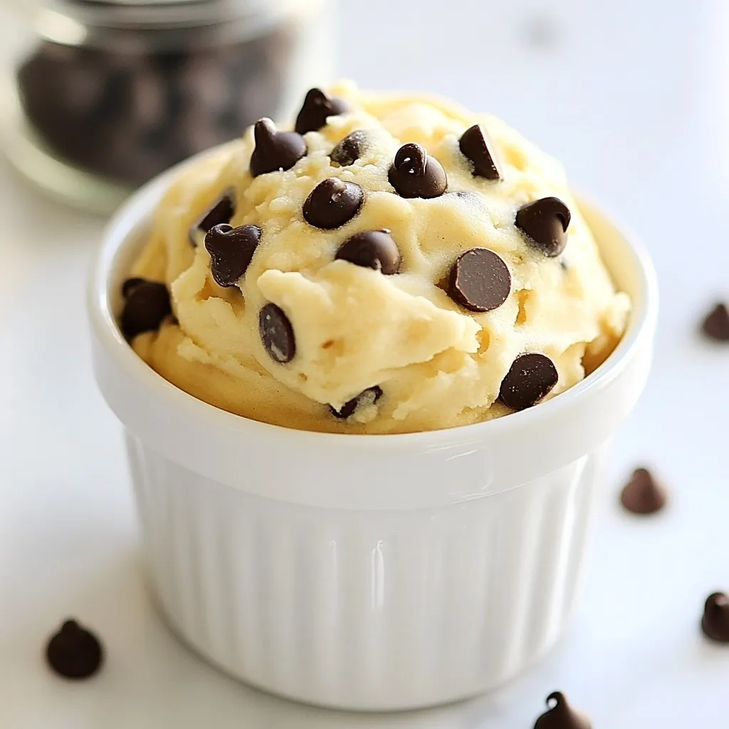 To make your single-serve edible cookie dough, gather these ingredients: - 3 tablespoons all-purpose flour - 1 tablespoon unsalted butter, softened to room temperature - 1 tablespoon packed brown sugar - 1 tablespoon granulated sugar - 1/4 teaspoon pure vanilla extract - 1 tablespoon milk (dairy or plant-based) - 2 tablespoons mini chocolate chips - A pinch of fine sea salt These simple items make a rich cookie dough that you can enjoy right away. You can swap ingredients to fit your taste or needs: - All-purpose flour can be replaced with oat flour for a gluten-free option. - Use coconut oil in place of unsalted butter for a dairy-free version. - If you’re out of brown sugar, regular granulated sugar works too. - For milk, any plant-based milk like almond or soy can be used. These swaps keep your cookie dough tasty and enjoyable. Want to customize your cookie dough? Here are some fun add-ins to try: - Chopped nuts for a crunchy texture. - Sprinkles for a colorful touch. - Peanut butter or almond butter for a nutty flavor. - Dried fruit for added sweetness. Experiment with these options to create your perfect treat! {{ingredient_image_2}} To make single-serve edible cookie dough, start by gathering your ingredients. You need: - 3 tablespoons all-purpose flour - 1 tablespoon unsalted butter, softened - 1 tablespoon packed brown sugar - 1 tablespoon granulated sugar - 1/4 teaspoon pure vanilla extract - 1 tablespoon milk (dairy or plant-based) - 2 tablespoons mini chocolate chips - A pinch of fine sea salt First, take a small mixing bowl. Add the softened butter, packed brown sugar, and granulated sugar. Mix these together with a fork or a hand mixer. Aim for a creamy and light texture. This takes just a minute or two. Next, stir in the pure vanilla extract and milk. Mix until it is smooth and well-combined. In another bowl, sift the all-purpose flour and fine sea salt. This step helps break up any lumps. Slowly fold this flour mixture into your wet mix. Keep stirring until you form a rich, cohesive dough. When your dough is ready, gently fold in the mini chocolate chips. Ensure they are spread evenly throughout the dough. At this point, taste your cookie dough! If you want a sweeter treat, add a bit more granulated sugar. Mix it in and taste again if needed. For a fun presentation, scoop the cookie dough into a small bowl or a cute jar. Top it with a few extra mini chocolate chips. This makes it look even more inviting. You can also serve the cookie dough with fresh fruit slices, like strawberries or apples. This adds a nice crunch and freshness to each bite. Enjoy your single-serve edible cookie dough right away for the best experience! To get the best texture, use room temperature butter. This helps blend well with sugars. Mix until creamy for a smooth dough. If your dough is too dry, add a bit more milk. If it’s too wet, add a sprinkle of flour. The goal is a soft, not sticky dough. Taste your cookie dough before serving. If you want it sweeter, add more sugar. Start with just a little at a time. Mix well after each addition to avoid overpowering the flavor. You can use brown sugar for a richer taste or keep it simple with granulated sugar. Watch out for these common errors: - Using cold butter: This makes mixing hard. Always use softened butter for a smooth blend. - Skipping the salt: A tiny pinch enhances flavor. Don't skip it! - Overmixing the dough: This can make it tough. Mix just until combined. By following these tips, you’ll create a delightful single-serve edible cookie dough that’s perfect every time! Pro Tips Use Heat-Treated Flour: To make your cookie dough safe to eat, consider using heat-treated flour. Spread it on a baking sheet and bake at 350°F (175°C) for about 5 minutes to kill any bacteria. Experiment with Flavors: Feel free to customize your cookie dough by adding different extracts like almond or coconut for a unique twist. Mix-Ins Galore: Get creative with your mix-ins! Try adding nuts, dried fruit, or even crushed cookies to enhance the texture and flavor. Chill for Extra Firmness: If you prefer a firmer dough, chill your cookie dough in the refrigerator for about 15 minutes before serving. {{image_4}} You can change the taste of your edible cookie dough easily. For a nutty twist, try adding one tablespoon of your favorite nut butter. Almond or peanut butter works great. This adds creaminess and flavor. If you want a fun and colorful treat, add a tablespoon of funfetti sprinkles. They make your cookie dough look festive and exciting. You can also use flavored extracts like almond or hazelnut for a unique taste. The options are endless! You can modify this recipe to fit your diet. To make it vegan, swap the butter for coconut oil or a plant-based butter. Use a plant-based milk, like almond or oat milk, to keep it dairy-free. For gluten-free cookie dough, replace all-purpose flour with almond flour or gluten-free flour blend. This way, everyone can enjoy this tasty treat without worry. Get creative with your mix-ins! You can add chopped nuts, dried fruit, or even crushed cookies for extra texture. Try mini marshmallows for a s'mores vibe, or add a tablespoon of cocoa powder for a chocolate version. Feel free to experiment and find your favorite combinations. The best part is that you can make it just the way you like! If you have leftover cookie dough, store it in an airtight container. This keeps it fresh and tasty. Place the container in the fridge. Your cookie dough will stay good for about three days. If you want to enjoy it later, freezing is a better option. To freeze your cookie dough, scoop it into small portions. You can use a cookie scoop or spoon. Place the scoops on a baking sheet lined with parchment paper. Freeze them for about an hour until they are solid. Once frozen, transfer the scoops to a freezer-safe bag. This way, you can grab one when a craving hits! When stored correctly, cookie dough lasts well in the fridge or freezer. In the fridge, it’s best used within three days. In the freezer, it can last up to three months. For the best flavor and texture, always thaw the frozen dough in the fridge overnight before enjoying. This keeps it soft and easy to eat. Yes, you can eat this cookie dough raw! This recipe uses heat-treated flour, making it safe. You will enjoy the creamy texture and sweet taste without any worries. Just remember, it is meant for one serving, so share if you want! If you need a substitute for all-purpose flour, try using almond flour or oat flour. Both options work well and add unique flavors. You can also use a gluten-free flour blend if you want to keep it gluten-free. Just remember to adjust the amount, as some flours absorb more liquid than others. Making single-serve edible cookie dough takes just 5 minutes. You can whip it up quickly for a tasty treat any time. Just gather your ingredients and mix them together. In no time, you will have delicious cookie dough ready to enjoy! This blog post covered all you need for single-serve edible cookie dough. We reviewed essential ingredients and substitutions, explored step-by-step instructions, and shared helpful tips. You learned about flavor variations, storage methods, and common questions. Remember, you can customize your cookie dough to fit your taste or diet. Now, you can enjoy this treat with confidence. There is no wrong way to create your unique dessert!