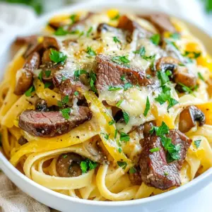 - 8 oz fettuccine pasta - 1 lb ribeye steak, thinly sliced against the grain - 1 tablespoon olive oil - 1 medium onion, thinly sliced - 1 green bell pepper, thinly sliced - 1 cup fresh mushrooms, sliced - 2 cloves garlic, minced - 1 cup beef broth (preferably low-sodium) - 1 cup heavy cream - 1 teaspoon Worcestershire sauce - 1 teaspoon smoked paprika - Salt and black pepper to taste - 1 ½ cups provolone cheese, shredded - Fresh parsley, chopped (for garnish) For this dish, you need specific amounts to make it right. Here’s a breakdown: - Pasta: Use 8 ounces of fettuccine. This gives a great base. - Steak: Use one pound of ribeye steak. Thin slices work best. - Olive oil: Just one tablespoon is enough for sautéing. - Vegetables: One medium onion and one green bell pepper keep the flavor bright. - Mushrooms: A cup of fresh mushrooms adds depth. - Garlic: Two cloves minced to enhance the taste. - Broth and cream: One cup each of beef broth and heavy cream creates a creamy sauce. - Seasonings: Use one teaspoon each of Worcestershire sauce and smoked paprika. Adjust salt and pepper to your liking. - Cheese: Shred one and a half cups of provolone. It melts beautifully. - Garnish: Fresh parsley adds a pop of color and freshness. If you can't find ribeye steak, you can use flank steak or sirloin. For a lighter option, you can swap heavy cream with half-and-half or a plant-based cream. Enjoy the cooking process and make it your own! {{ingredient_image_2}} To cook the fettuccine pasta, bring a large pot of salted water to a rolling boil. Add the pasta and cook it until it is al dente, which means it should have a slight bite. This usually takes about 8-10 minutes. Once cooked, drain the pasta well and set it aside. Make sure to save a little pasta water in case you need it later. Heat a large skillet over medium heat and add olive oil. Once hot, add the thinly sliced onions and green bell peppers. Sauté them for about 4-5 minutes until they soften. Then, add the sliced mushrooms and minced garlic. Cook this mix for another 2 minutes. Layering these flavors builds a rich taste that enhances the dish. After the vegetables are done, push them to one side of the skillet. Increase the heat to medium-high. Add the thinly sliced ribeye steak to the other side. Season with salt, black pepper, and smoked paprika. Sear the steak for about 3-4 minutes until it is browned. Mix everything together for an even flavor. Pour in the beef broth and bring it to a gentle simmer. Stir in the heavy cream and Worcestershire sauce. Allow the sauce to thicken for about 3-5 minutes. Taste and adjust the seasoning as needed. This creamy sauce is key to making your dish rich and delicious. Add the drained fettuccine directly into the skillet with the sauce. Toss everything together until the pasta is well coated. Gradually stir in 1 cup of shredded provolone cheese. Mix until the cheese melts and creates a creamy texture. This step makes the pasta extra comforting. Plate the cheesesteak pasta, and sprinkle additional provolone cheese on top. For a crispy finish, you can place the plates under the broiler for about 2 minutes. This step makes the cheese bubbly and golden. Don’t forget to add a sprinkle of freshly chopped parsley for a bright touch. To make your Philly Cheesesteak Pasta truly sing, focus on some key techniques: - Sear the steak well: Heat your skillet until it's hot. This helps create a nice crust. - Layer your flavors: Start with the onions and bell peppers, then add mushrooms and garlic. Each layer adds depth. - Use a big skillet: This gives you space to cook and stir without spills. For tools, keep these handy: - A large skillet for sautéing. - A pot for boiling pasta. - A sharp knife for slicing steak and veggies. Avoid these typical errors: - Overcooking the steak: It should be browned but not dried out. Look for a nice sear. - Undercooking the pasta: Aim for al dente. This keeps the pasta from getting mushy in the sauce. - Forgetting to taste the sauce: Adjust seasoning before mixing in the pasta. A little salt and pepper go a long way. Signs of overcooked steak include a tough texture. Undercooked pasta will be hard in the center. You can easily customize this dish: - Add spices: Try crushed red pepper flakes for heat. Smoked paprika adds a nice depth too. - Change up the veggies: Add spinach or zucchini for extra nutrition. - Dietary preferences: If you want it vegetarian, use mushrooms or tempeh instead of steak. Substitute the cream with coconut milk for a dairy-free option. Feel free to mix and match to make it your own! Pro Tips Choose the Right Cut: Ribeye steak is ideal for its marbling and flavor, but you can substitute with flank steak for a leaner option. Layering Flavors: Searing the steak after sautéing the vegetables enhances the depth of flavor in your dish, so don’t skip this step! Perfectly Cooked Pasta: Make sure to cook the pasta just until al dente, as it will continue to cook slightly when combined with the sauce. Extra Creaminess: For an even richer sauce, add a splash of cream cheese or mascarpone just before serving for extra creaminess. {{image_4}} For a veggie twist, replace the ribeye steak with mushrooms or tempeh. Both add great texture and flavor. Use a mix of mushrooms like portobello and shiitake for a rich taste. To make the sauce vegetarian-friendly, swap beef broth for vegetable broth. This keeps the dish hearty and delicious while being meat-free. If you need a gluten-free meal, choose gluten-free pasta like brown rice or quinoa pasta. These options work well and cook similarly to regular pasta. When making the sauce, double-check that your Worcestershire sauce is gluten-free. This will help avoid any gluten sensitivity issues, allowing everyone to enjoy the meal. To spice things up, add jalapeños or a splash of hot sauce. Slice jalapeños thinly and mix them in while cooking the vegetables. Start with a small amount and taste as you go. This keeps the flavors balanced and not too overpowering. If you like it really hot, feel free to add more! To store leftovers safely, let the pasta cool to room temp. Place it in an airtight container. This way, it stays fresh for up to three days. Use glass or BPA-free plastic containers. They help avoid strong smells and keep the food safe. Reheat the pasta on the stove for best results. Add a splash of beef broth or cream to keep it moist. Stir it gently over medium heat until warm. You can also use the microwave. Cover the dish to prevent it from drying out. Heat it in short bursts, stirring often. If you want to freeze the dish, cool it completely first. Use freezer-safe containers or bags. Remove excess air to prevent freezer burn. Thaw it in the fridge overnight before reheating. Reheat it slowly on the stove or in the microwave for best texture. If you can't find ribeye steak, don't worry! You can use other cuts of beef. Here are some great alternatives: - Flank steak: Thin and flavorful, it cooks well. - Sirloin: A bit leaner but still tasty. - Chuck roast: Tender when cooked slowly, great for flavor. These cuts work well in this dish, so feel free to experiment! You can easily make this dish dairy-free by swapping out the cream and cheese. Here are some options: - Use coconut cream or cashew cream instead of heavy cream. - For cheese, try dairy-free cheese shreds or nutritional yeast. These substitutes keep the dish creamy and delicious without dairy! Yes, you can prep this dish ahead of time! Here are some tips: - Cook the pasta and veggies, then store them separately. - Sear the steak and make the sauce, then cool before storing. When ready to eat, just combine and heat everything together. It makes mealtime easy! Pair this hearty pasta with some tasty sides. Here are my favorites: - Garlic bread for dipping in the sauce. - A simple green salad for a fresh crunch. - Roasted vegetables to add more flavor. These sides complement the dish well! This recipe is not very spicy. However, you can adjust the heat to your taste. Here’s how: - Add crushed red pepper flakes while cooking the steak for a kick. - Toss in some jalapeños for extra heat. Just remember to balance the spice with creamy sauce for best flavor! In this post, we explored making Philly Cheesesteak Pasta. We covered essential ingredients, cooking techniques, and serving tips. You learned how to make alternatives for dietary needs and avoid common mistakes. My final thoughts? This dish is fun and versatile. Whether you like it spicy or creamy, you can customize it. Enjoy the cooking process. With practice, you’ll impress friends and family with this tasty meal. Dive in and make it your own!