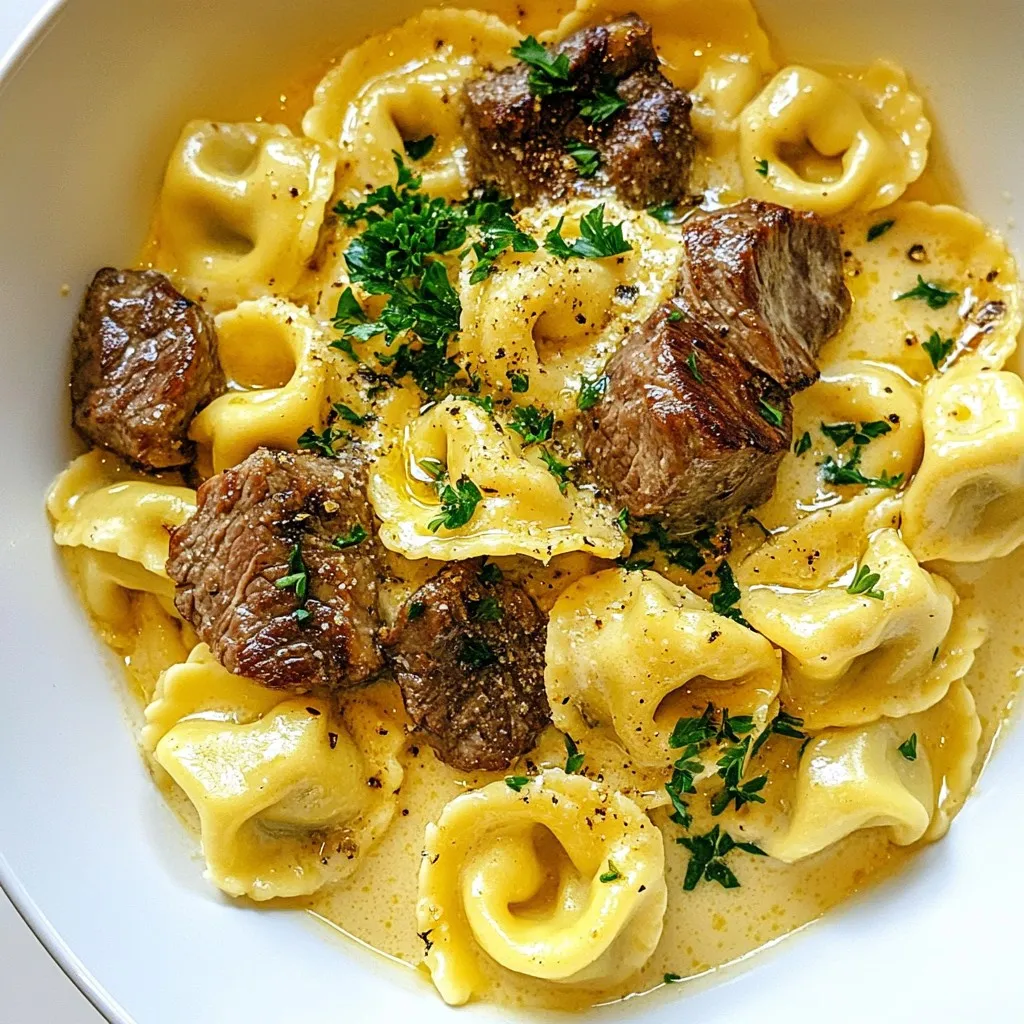 - Cheese tortellini: You need 8 oz of cheese tortellini. It adds a rich flavor and fun texture. Look for fresh or dried tortellini at your store. - Steak options and cut details: Use 1 lb of steak. Sirloin or ribeye works best. Cut it into bite-sized pieces for quick cooking. These cuts are tender and full of flavor. - Garlic and seasoning specifics: You will need 4 cloves of garlic, minced. Garlic gives a strong taste. Add 1 teaspoon of Italian seasoning for warmth. Salt and pepper are key for seasoning, so don’t skip them. - Cream and cheese choices: For a creamy base, use 1 cup of heavy cream. It makes your sauce rich. Add 1 cup of grated Parmesan cheese for a cheesy finish. This will melt into the sauce and add depth. {{ingredient_image_2}} Start by filling a large pot with salted water and bring it to a boil. This step is key. Once the water boils, add 8 oz of cheese tortellini. Cook according to the package instructions, usually around 3-5 minutes. The goal is to achieve that perfect al dente bite. After cooking, carefully drain the tortellini in a colander and set it aside. Next, grab a large skillet and add 2 tablespoons of olive oil. Heat it over medium-high heat. While the oil heats, season 1 lb of steak with salt and pepper. Once the oil shimmers, place the steak pieces into the skillet. Sear the steak for about 3-4 minutes, turning them as needed. You want a nice brown crust. When done, remove the steak from the skillet and cover it to keep warm. Now, we’ll make the sauce. In the same skillet, lower the heat to medium and add 1 tablespoon of olive oil. Once hot, add 4 minced cloves of garlic. Sauté the garlic for about 30 seconds, stirring often. Be careful not to burn it, as burnt garlic is bitter. Next, gently pour in 1 cup of heavy cream. Stir while bringing it to a gentle simmer. Gradually add 1 cup of grated Parmesan cheese and 1 teaspoon of Italian seasoning. Mix until the cheese is melted and the sauce is creamy. It’s time to bring it all together! Add the seared steak back into the skillet. Then, fold in the cooked tortellini. Make sure each piece is well coated in that creamy garlic sauce. For the final touch, taste the dish and adjust the seasoning with more salt or pepper if needed. To cook tortellini perfectly, follow these steps: - Use a large pot of salted water. This adds flavor to the pasta. - Cook until al dente. This means it should be firm but not hard. - Drain it gently and do not rinse. Rinsing removes the starch that helps sauce stick. Common mistakes include: - Overcooking the pasta. This makes it mushy. - Not salting the water. This makes the pasta bland. Choosing the right steak makes a big difference. I recommend using: - Sirloin for a lean cut. - Ribeye for more flavor and fat. For ideal doneness, use these tips: - Sear for 3-4 minutes on each side for medium-rare. - Use a meat thermometer. Aim for 130°F for medium-rare, 140°F for medium. You want a creamy sauce that coats everything well. Here’s how to adjust the creaminess: - If too thick, add a splash of pasta water to loosen it. - If too thin, let it simmer longer to thicken. To add flavors or spices: - Try adding red pepper flakes for heat. - Fresh herbs like basil or thyme can brighten the dish. Pro Tips Choose the Right Steak: Opt for cuts like sirloin or ribeye for a tender and flavorful result. These cuts will sear beautifully and complement the creamy sauce perfectly. Don’t Overcook the Garlic: Sauté the garlic just until fragrant to avoid bitterness. Overcooking can ruin the delicate flavor of your sauce. Use Fresh Parmesan: Grate your Parmesan cheese fresh for the best flavor and texture. Pre-grated cheese often contains anti-caking agents that can affect the creaminess of your sauce. Garnish for Flavor: Fresh parsley not only adds a pop of color but also enhances the dish's flavor profile. Don’t skip this step for a fresh finish! {{image_4}} You can switch the steak for chicken or shrimp. Both options taste great with the creamy garlic sauce. Chicken cooks quickly, so slice it thin for even cooking. Shrimp adds a sweet flavor, perfect with garlic. For a vegetarian twist, use plant-based meat. It absorbs the sauce well and keeps the dish rich. Adding veggies can take this dish to the next level. Spinach wilts nicely and adds color. Mushrooms bring a lovely earthy taste. You might also try mixing in different cheeses. Gouda or mozzarella can create a fun flavor twist. Each cheese melts differently, so choose what you enjoy most. If you're gluten-free, use gluten-free tortellini. Many brands offer tasty options. For dairy-free needs, try coconut cream or a nut-based cheese. These swaps keep the dish rich without dairy. If you're watching carbs, use zucchini noodles instead of tortellini. It’s a fresh take that still feels hearty. Store your leftovers in the fridge. Use airtight containers to keep them fresh. Make sure the dish cools to room temperature first. This helps prevent moisture buildup. Label the container with the date. This way, you know when to eat it. Reheat creamy garlic steak tortellini on the stove. Use a medium heat setting. Add a splash of cream or broth to keep it moist. Stir continuously to avoid sticking. You can also use a microwave. Heat it in short bursts, stirring in between. This helps keep the dish creamy and delicious. You can freeze this dish for later. Use freezer-safe containers to avoid freezer burn. Let the tortellini cool completely before sealing. It can last for up to three months in the freezer. For reheating, thaw it in the fridge overnight. Then, warm it on the stove or microwave. Add cream to refresh the flavors after thawing. To make creamy garlic steak tortellini from scratch, you need a few key ingredients: - 8 oz cheese tortellini - 1 lb steak (sirloin or ribeye), cut into bite-sized pieces - 3 tablespoons olive oil, divided - 4 cloves garlic, minced - 1 cup heavy cream - 1 cup grated Parmesan cheese - 1 teaspoon Italian seasoning - Salt and pepper to taste - Fresh parsley, chopped (for garnish) Start by boiling salted water and cooking the tortellini until al dente. Drain and set aside. Next, heat two tablespoons of olive oil in a skillet. Season your steak with salt and pepper. Sear the steak for 3-4 minutes until browned. Remove the steak and keep it warm. In the same skillet, lower the heat and add the last tablespoon of olive oil. Sauté the minced garlic for about 30 seconds. Be careful not to burn it. Pour in the cream and let it simmer. Stir in the Parmesan cheese and Italian seasoning until it's creamy. Finally, add the steak and tortellini back into the skillet. Mix gently until every piece is coated in the sauce. Taste and adjust seasoning as needed. Yes, you can use frozen tortellini! If you choose frozen tortellini, cook it according to the package instructions. This usually takes a few minutes longer than fresh tortellini. Once cooked, drain it and add it to your creamy garlic sauce just like fresh tortellini. The sauce will still coat the frozen tortellini beautifully. Here are some great ideas for sides: - A fresh green salad with a light vinaigrette - Garlic bread for soaking up the creamy sauce - Steamed broccoli or asparagus to add some color For wine pairings, consider a light red wine like Pinot Noir or a crisp white wine like Sauvignon Blanc. Both will complement the rich flavors of the tortellini and steak. In this blog post, I covered how to make creamy garlic steak tortellini. We explored the key ingredients, cooking steps, and helpful tips for perfect results. Remember, choosing the right steak cut is crucial for flavor. Experiment with variations to suit your taste and dietary needs. Proper storage and reheating can help you enjoy leftovers without losing quality. Now, you have all the tools you need to create a delicious meal. Dive in and savor every bite of your homemade dish!