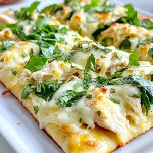 To make Chicken Alfredo Flatbread, you need these key ingredients: - 1 large flatbread (store-bought or homemade) - 1 cup cooked chicken breast, shredded - 1 cup Alfredo sauce (store-bought or homemade) - 1 cup mozzarella cheese, shredded - 1/2 cup Parmesan cheese, grated - 1 cup fresh spinach leaves - 1 clove garlic, minced - 1 tablespoon olive oil - Salt and pepper to taste - Optional: Fresh parsley, chopped (for garnish) These ingredients combine to create a rich and creamy flavor that everyone will love. When picking Alfredo sauce, I recommend brands like Classico or Rao's. They have great taste and quality. For cheese, I love using Whole Foods' mozzarella and Parmigiano-Reggiano. These brands melt well and add depth to your dish. You can make some easy swaps for a healthier flatbread. Try using whole wheat flatbread instead of regular. For a lighter sauce, consider using Greek yogurt mixed with a bit of milk. You can also opt for low-fat cheeses to cut calories. If you want extra veggies, add bell peppers or mushrooms for more nutrition. {{ingredient_image_2}} Start by gathering your ingredients. You will need: - 1 large flatbread (store-bought or homemade) - 1 cup cooked chicken breast, shredded - 1 cup Alfredo sauce (store-bought or homemade) - 1 cup mozzarella cheese, shredded - 1/2 cup Parmesan cheese, grated - 1 cup fresh spinach leaves - 1 clove garlic, minced - 1 tablespoon olive oil - Salt and pepper to taste - Optional: Fresh parsley, chopped (for garnish) Preheat your oven to 400&deg;F (200&deg;C). This step is key for a great bake. While the oven heats, shred your cooked chicken and mince the garlic. Measure out your cheese and sauce. Having everything ready makes cooking smoother. Grab a medium skillet and add the olive oil over medium heat. Once the oil is warm, add the minced garlic. Saut&eacute; the garlic for about one minute. Watch it closely; you don't want it to brown. Next, add the shredded chicken to the skillet. Season it with salt and pepper. Pour in half of the Alfredo sauce and mix well. Cook this mixture for 2-3 minutes, stirring often. Your goal is to heat the chicken and coat it with that creamy sauce. Now, take a baking sheet and place your flatbread on it. Use a spoon to spread the remaining Alfredo sauce evenly on the flatbread. Leave a small border around the edges for a nice crust. Next, evenly distribute the chicken mixture over the sauce. Make sure every bite gets that rich flavor. Then, sprinkle the shredded mozzarella on top. Follow it with the grated Parmesan cheese for extra flavor. Finally, scatter the fresh spinach leaves on top. Press the spinach down slightly so it sticks to the cheese. Place the flatbread in the preheated oven and bake for 10-12 minutes. You want the cheese to melt and bubble, with the edges turning golden brown. Once baked, take the flatbread out and let it cool for a couple of minutes. This helps avoid burns. Slice it into wedges, and feel free to garnish with chopped parsley. Your Chicken Alfredo Flatbread is now ready to enjoy! To make a great Alfredo sauce, start with fresh ingredients. Use heavy cream for a rich taste. If you want, add butter for extra creaminess. Heat the cream gently and whisk in grated Parmesan cheese. This helps create a smooth sauce. Stir until the cheese melts completely. Taste and add salt and pepper as needed. Avoid high heat, as it can scorch the sauce. For more flavor, add a pinch of nutmeg or garlic powder. Baking your flatbread correctly gives it a nice crunch. Preheat your oven to 400&deg;F (200&deg;C) to get the heat right. Place the flatbread directly on the oven rack for more even baking. This allows the bottom to crisp up nicely. Bake for 10-12 minutes, but keep an eye on it. The edges should turn golden brown. If you prefer a crunchier base, you can pre-bake the flatbread for 5 minutes before adding your toppings. Presentation makes your meal more inviting. Serve the flatbread on a wooden board for a rustic look. Cut it into wedges for easy sharing. Garnish with fresh parsley for color and flavor. You can add a small bowl of marinara sauce for dipping. This adds a nice touch and extra flavor. Don't forget to enjoy it while it's warm! Pro Tips Use Fresh Ingredients: Opt for fresh spinach and quality cheeses to enhance the flavor and texture of your flatbread. Customize Your Sauce: Feel free to add herbs or spices to your Alfredo sauce for an extra kick of flavor. Experiment with Toppings: Try adding sun-dried tomatoes, artichokes, or even bacon bits for a unique twist on this classic dish. Perfectly Crispy Crust: For an extra crispy flatbread, bake it on a pizza stone or preheated baking sheet. {{image_4}} You can switch up the chicken for many other proteins. Try shredded turkey for a lighter option. If you love seafood, shrimp works great too. For a smoky touch, add some diced bacon or pancetta. These swaps keep the dish exciting while still being tasty. If you want a veggie version, skip the chicken. Use grilled zucchini or roasted bell peppers instead. You can also try artichoke hearts for a unique flavor. Add mushrooms for a hearty feel. These options keep the dish flavorful and filling without meat. To boost flavor, add fresh herbs like basil or oregano. A sprinkle of red pepper flakes adds heat. For a hint of freshness, squeeze some lemon juice on top. You can also mix in some Italian seasoning for depth. These simple changes take your flatbread to a new level! To keep your Chicken Alfredo Flatbread fresh, let it cool first. Wrap it tightly in plastic wrap or foil. You can also place it in an airtight container. Store it in the fridge for up to three days. This keeps the flavors intact and prevents drying out. When you&rsquo;re ready to eat the leftovers, preheat your oven to 350&deg;F (175&deg;C). Place the flatbread on a baking sheet. Heat it for about 10 minutes, or until it is warm and the cheese melts slightly. You can also use a microwave. If using a microwave, place a damp paper towel over the flatbread. Heat for 1-2 minutes. This method helps keep it soft. If you want to save some for later, freezing is a great option. Wrap the flatbread tightly in plastic wrap and then in foil. This helps prevent freezer burn. Store it in the freezer for up to two months. When you want to eat it, thaw it overnight in the fridge. Then, reheat it in the oven as mentioned above. This way, you can enjoy a tasty meal anytime! Yes, you can use other types of bread. Try using naan, pita, or even a tortilla. Each bread type gives a unique taste and texture. Just make sure it can hold the toppings well. Thin crusts work best for a crispy bite, while thicker ones add a chewy texture. I love serving Chicken Alfredo Flatbread with fresh sides. Here are some great options: - Garden salad: A crisp, green salad balances the creamy flatbread. - Steamed veggies: Broccoli, green beans, or carrots offer a nice crunch. - Garlic bread: A classic side that complements the meal's flavors. - Marinara sauce: Perfect for dipping and adds a nice tang. Making Chicken Alfredo Flatbread is quick. It takes about 25 minutes in total: - Prep time: 10 minutes to gather and prepare your ingredients. - Cooking time: 10-12 minutes to bake it in the oven. This dish is great for a fast weeknight meal! In this blog post, I shared the key ingredients for Chicken Alfredo Flatbread. I provided step-by-step instructions and tips to perfect the dish. Variations allow for custom flavors, while storage tips ensure leftovers stay fresh. Keep these ideas in mind to create a meal that suits your taste. Chicken Alfredo Flatbread is simple to make and enjoy. You can easily adapt it for different diets. Cooking can be fun, and this dish showcases how creative you can be. Enjoy making your flatbread just the way you like it!